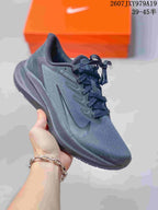 Charcoal gray Nike running sneaker with a dark outsole and matching laces.