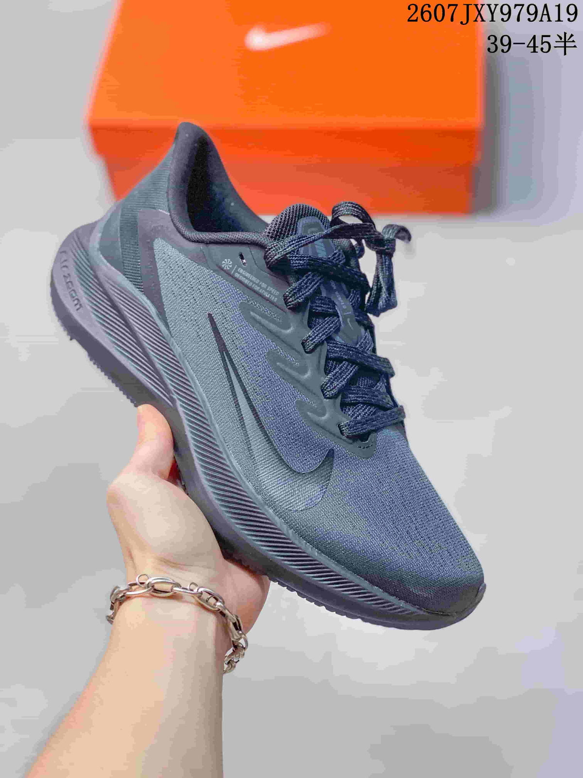 Charcoal gray Nike running sneaker with a dark outsole and matching laces.