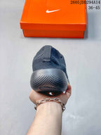 Rear view showing the padded heel and textured outsole of the dark gray Nike Free sneaker.