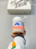 Rear view showing the blue Nike SB heel logo and orange outsole accent.