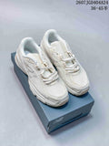 Pair of beige New Balance 740 sneakers displayed on a New Balance shoebox.