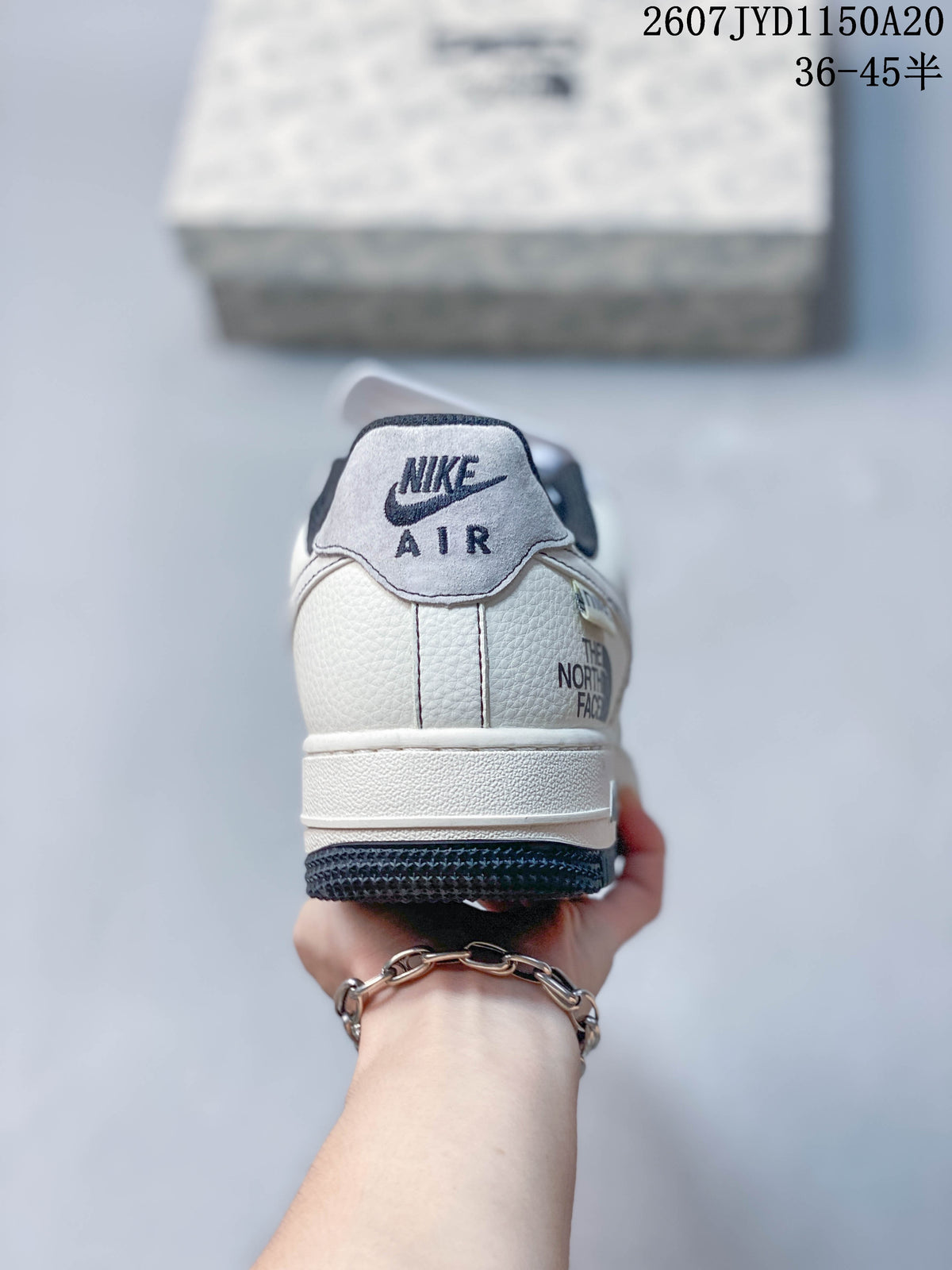 Rear view of the sneaker showing the Nike Air tongue label, white heel panel and visible The North Face branding detail.