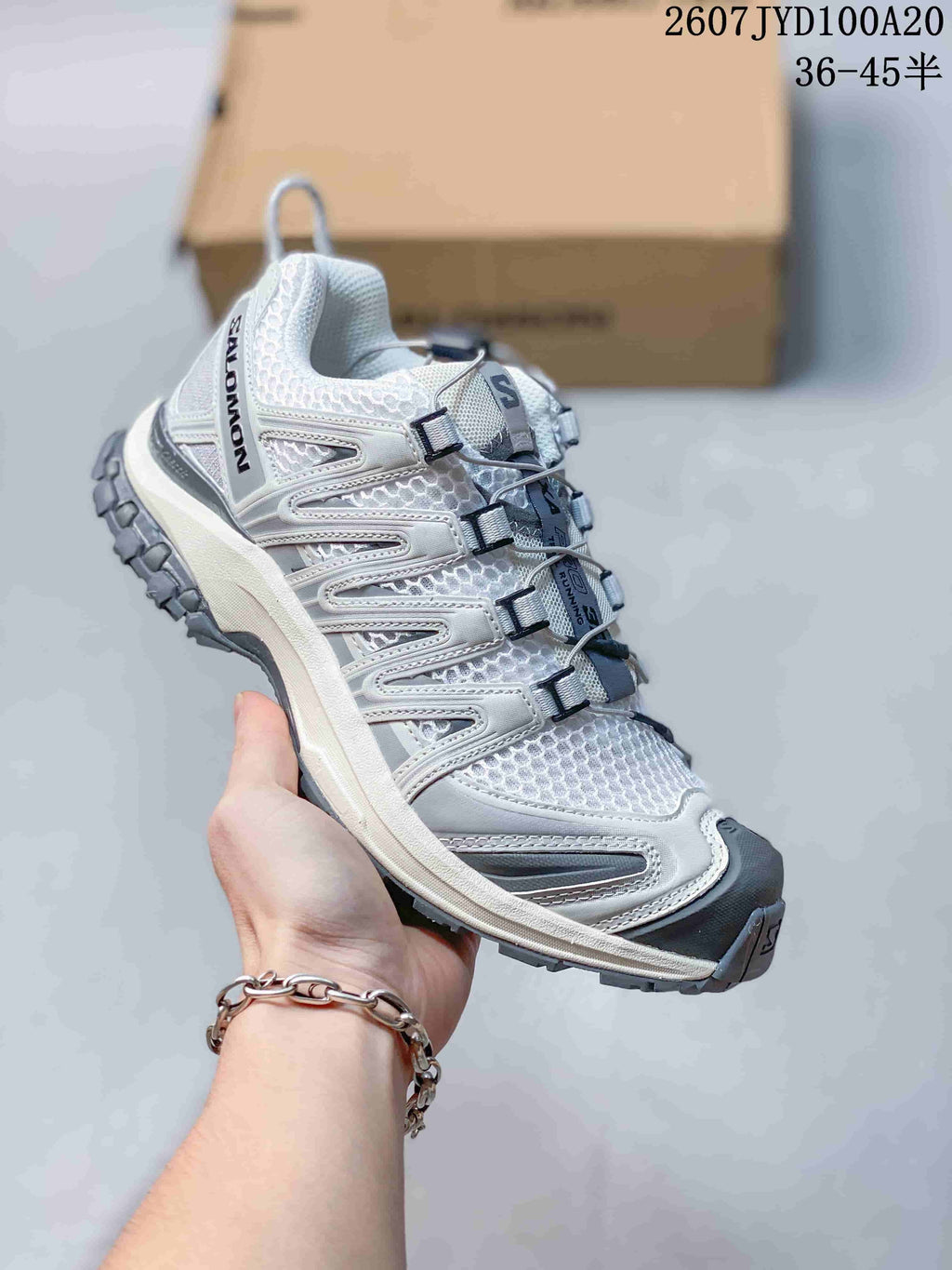 White and gray Salomon XA PRO 3D trail shoe showing the side overlays, mesh panels and outsole lugs.