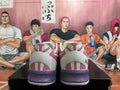 Rear view of pink and white basketball shoes with purple-speckled midsoles and geometric heel details.