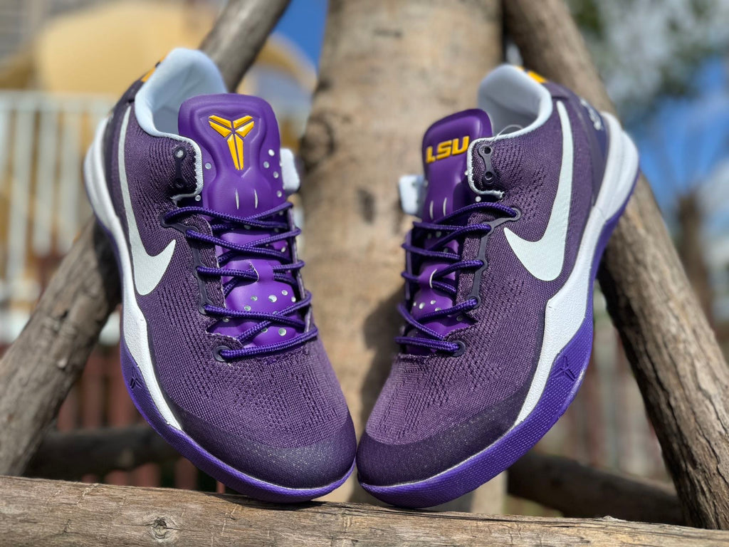Front view of purple Kobe 8 shoes with gold Kobe logo details.