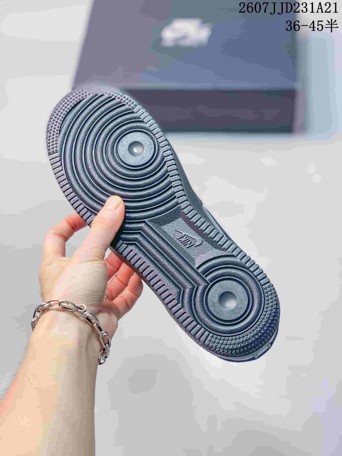 Close view of the black sneaker outsole showing its circular traction pattern and central Nike branding.