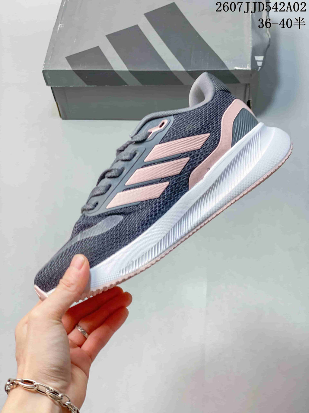 Side view showing the gray upper, pink accents, and white midsole.