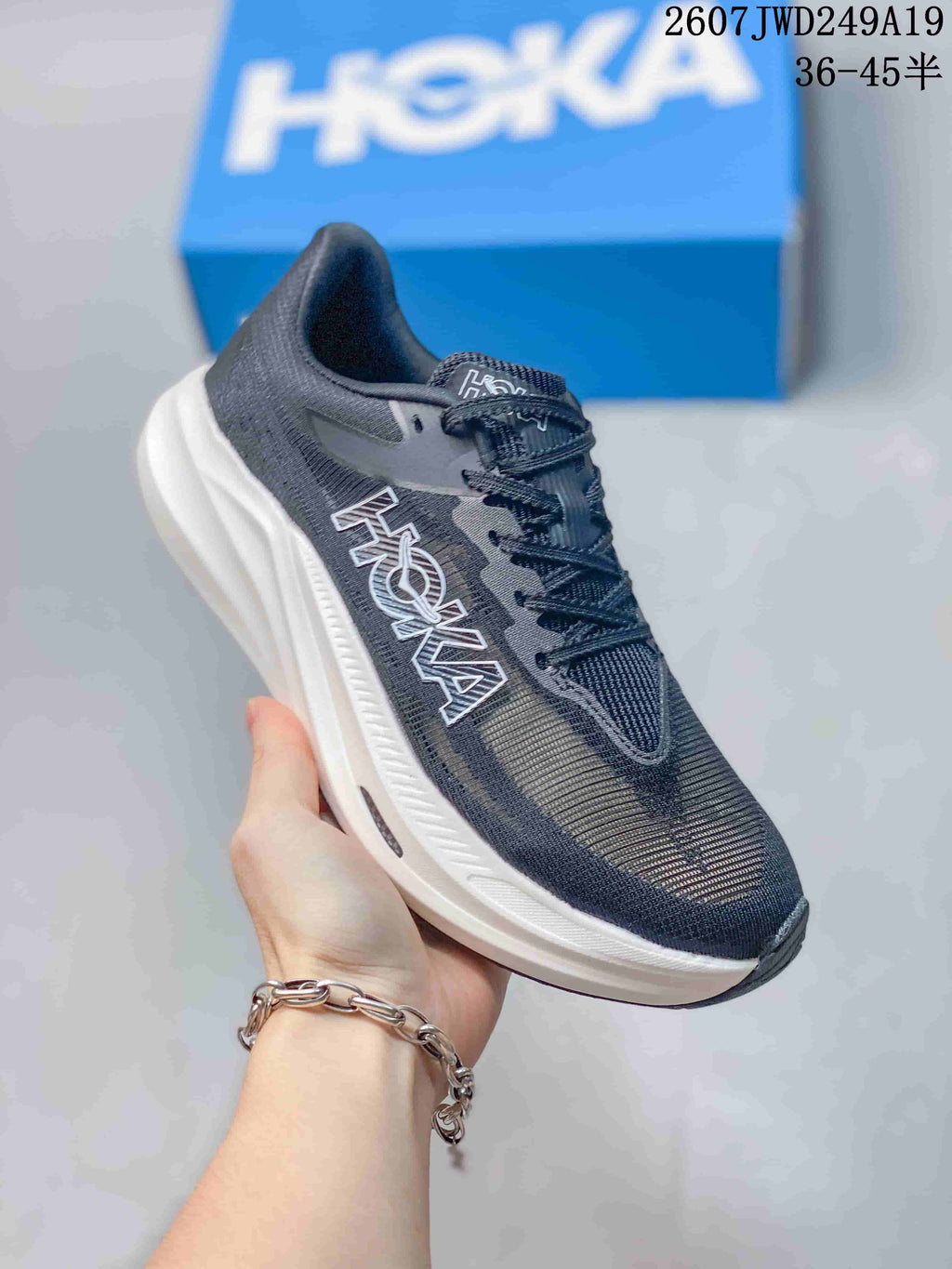 Black and dark gray Hoka One One MAFATE X shoe with a white sculpted sole.