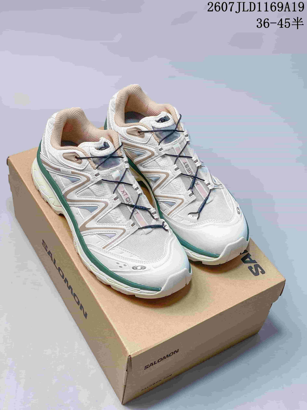 Pair of white and green Salomon XT-Quest sneakers displayed on a Salomon shoebox; the image also shows style code 2607JLD1169A19 and size range 36–45.