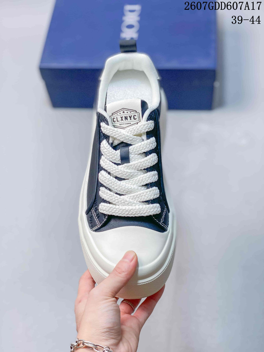 Top view of one sneaker showing the lace-up front, white toe cap, and tongue label.