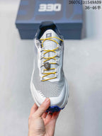 Top view showing the grey textile-style toe box, yellow laces, and central quick-lace dial.