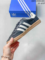 Side profile showing dark woven-look panels and white stripes