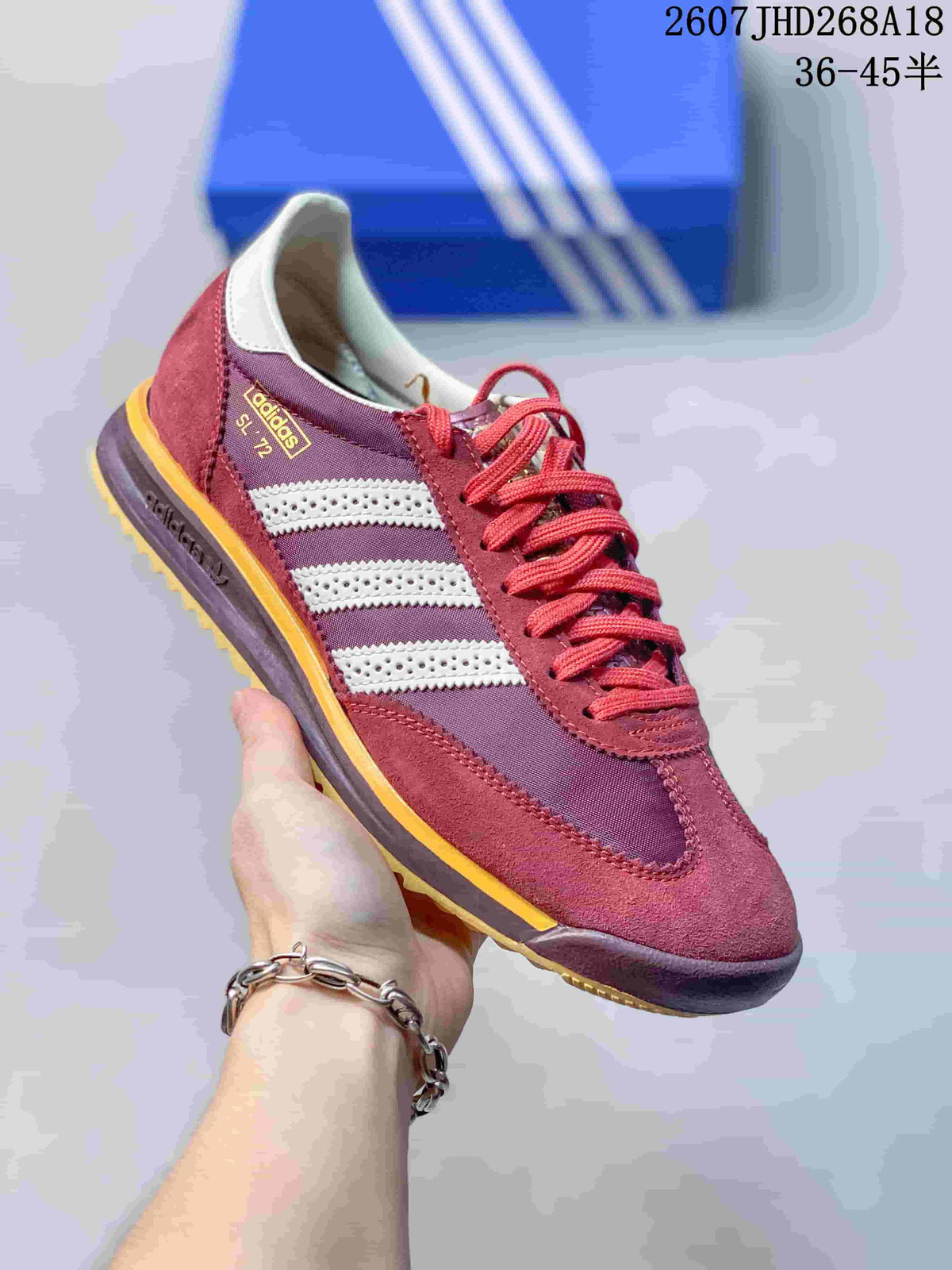 Side view of a burgundy adidas SL 72 sneaker showing the three stripes, lace-up design, layered outsole, and SL 72 branding.