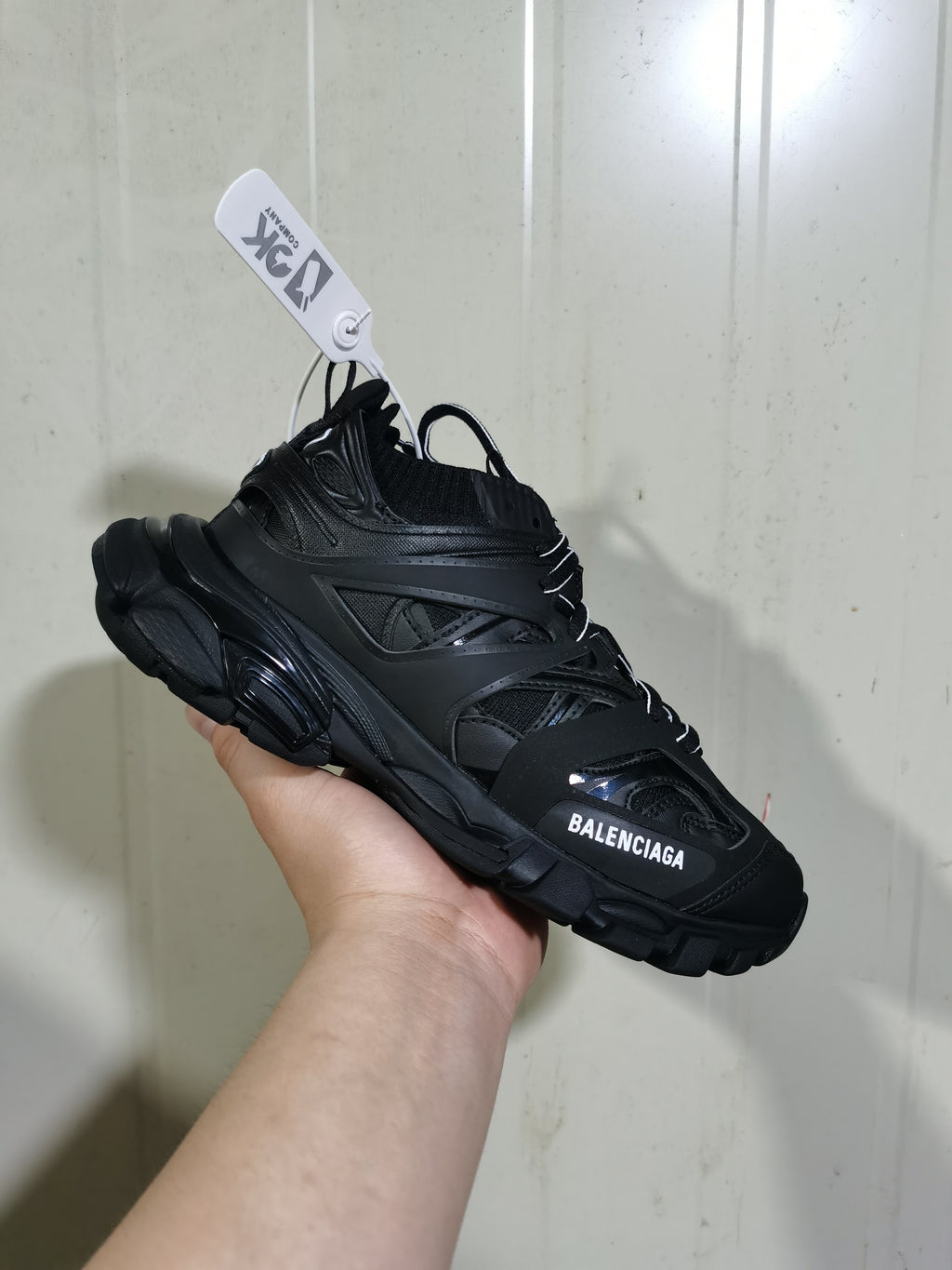 Black Balenciaga Track Sock sneaker shown from a front three-quarter angle, highlighting the layered upper, chunky sole, and logo detail.