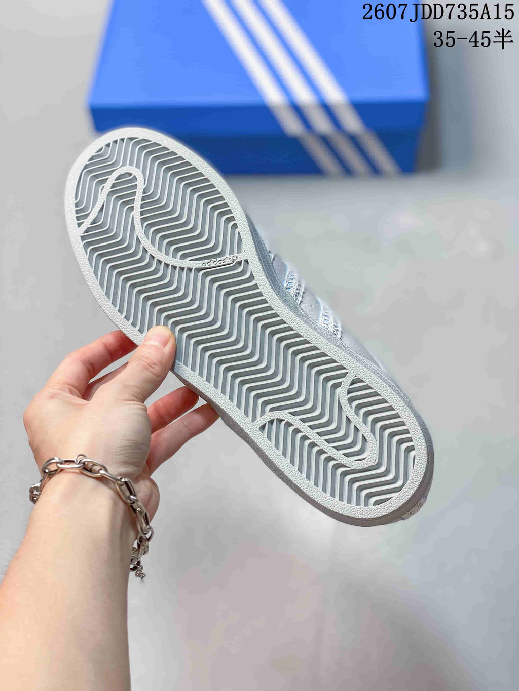 Bottom view of the sneaker showing the gray patterned rubber outsole.