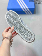 Bottom view of the sneaker showing the gray patterned rubber outsole.