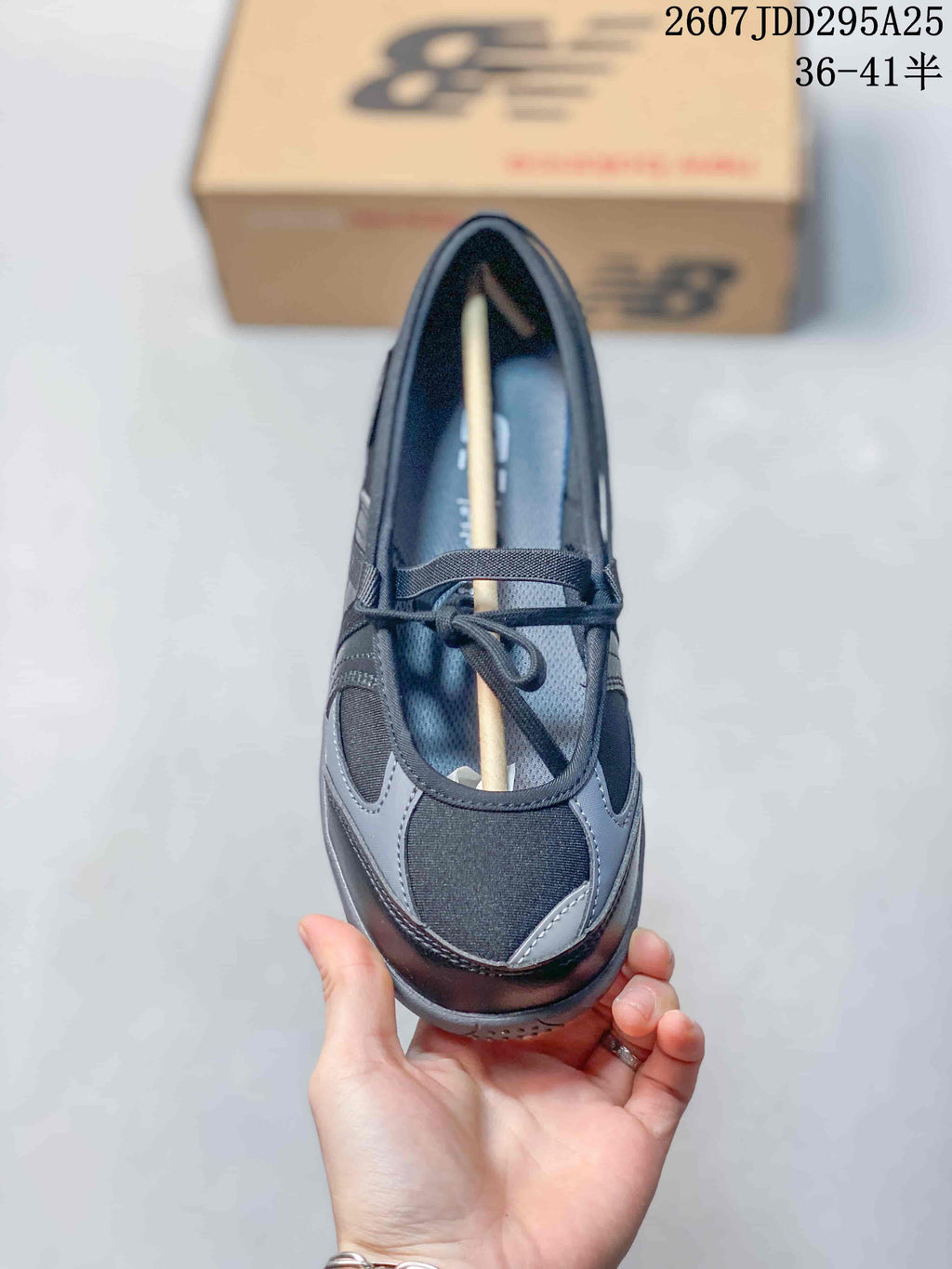 Top view showing the rounded T-toe shape, gray overlays, lace closure, and adjustable upper strap.