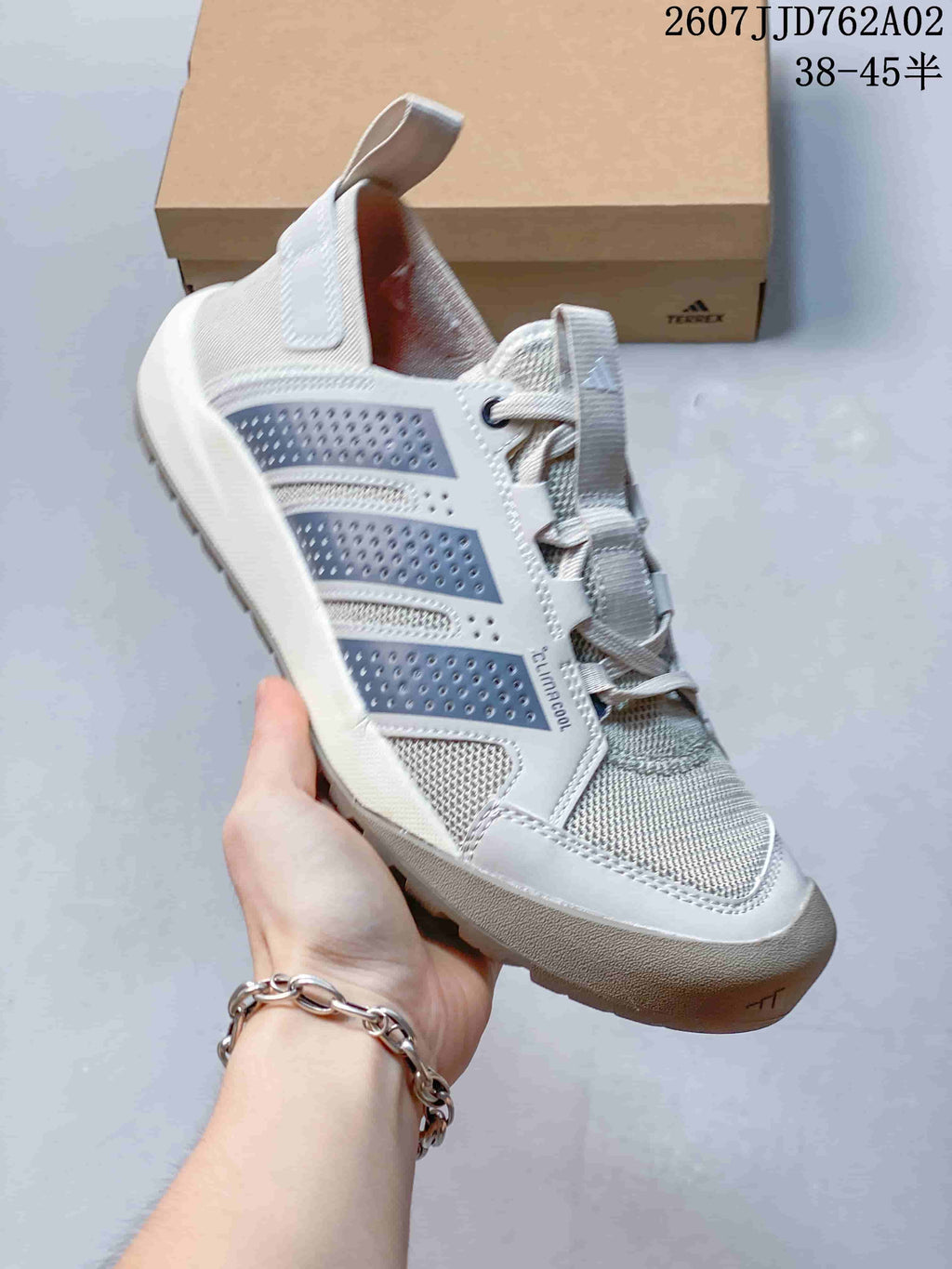 Light grey Adidas Terrex Daroga 25 shoe shown in profile with perforated side overlays and a rugged-looking outsole.