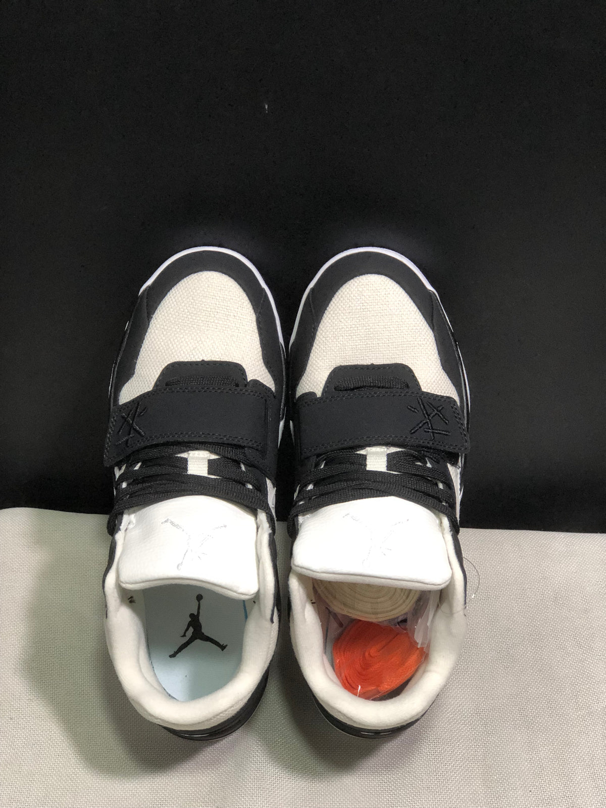 Top-down view showing the laces, adjustable midfoot straps, padded collars, and branded insoles.