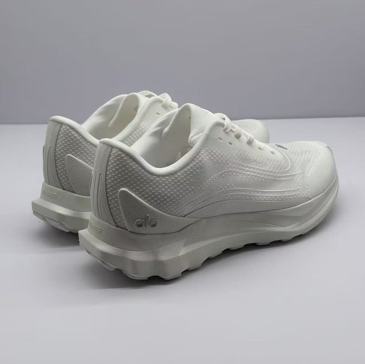 Rear three-quarter view showing the padded heel collars, heel branding, and outsole edge.