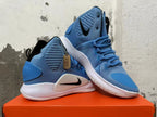 Pair of blue high-top basketball shoes shown from the side and at an angle.
