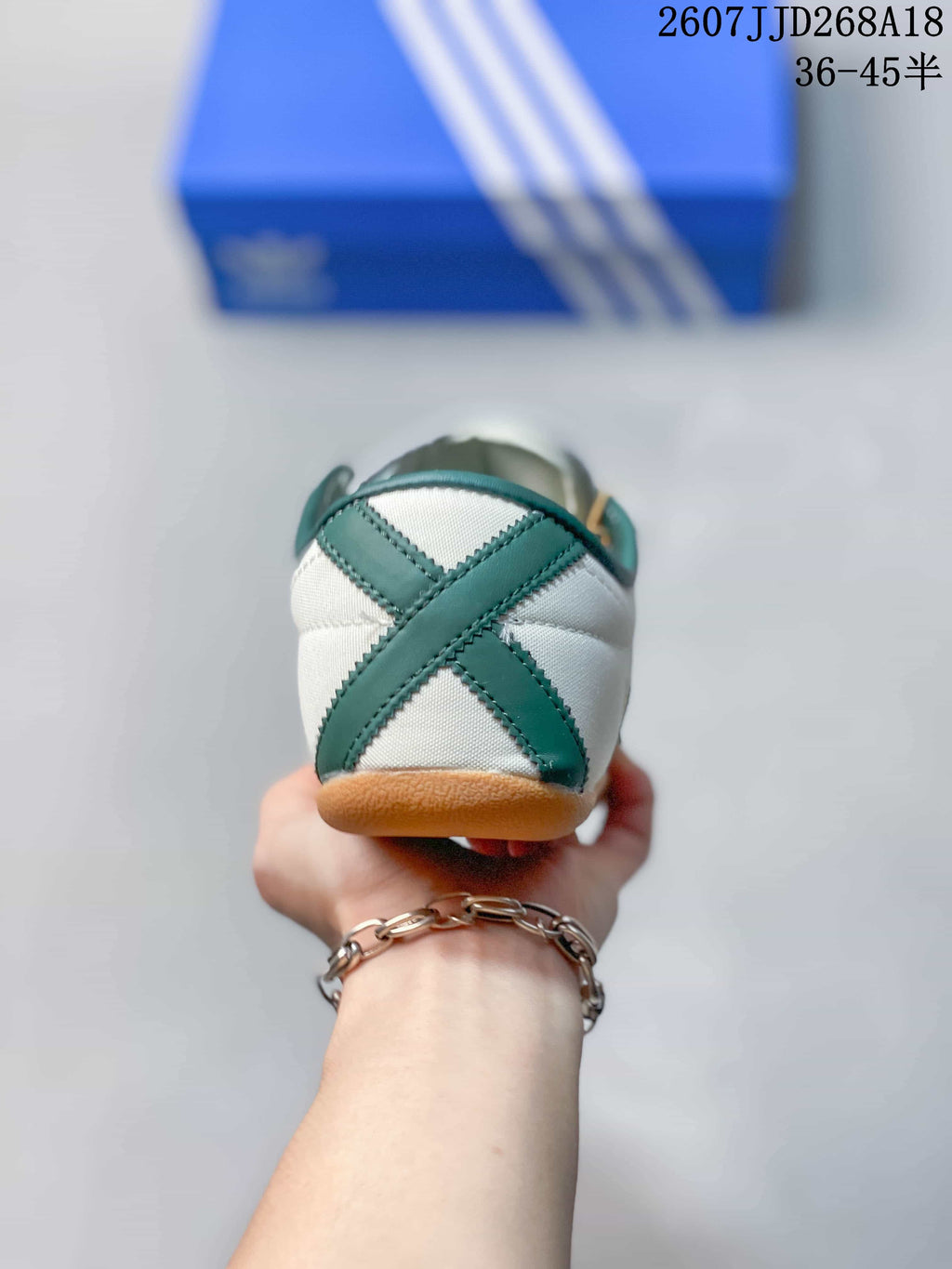 Rear view showing the green crossed heel detail and gum-colored outsole.