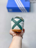 Rear view showing the green crossed heel detail and gum-colored outsole.