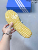 Close-up of the textured gum-colored outsole with circular and geometric tread details.