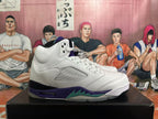 Side view of a white high-top sneaker with purple and teal midsole accents and translucent side panel