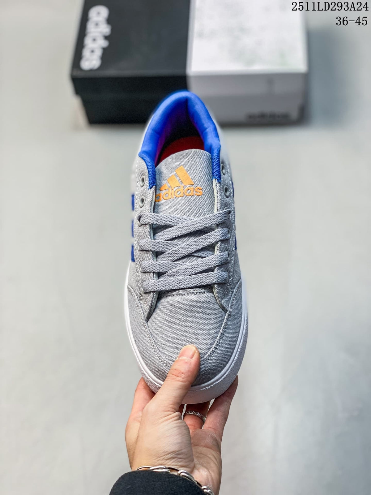 Top view of the grey lace-up sneaker with orange tongue branding and blue collar lining.