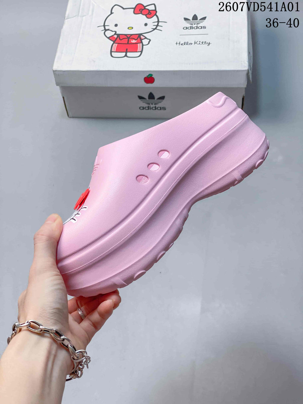 Side view of the pink clog showing its platform sole and side openings