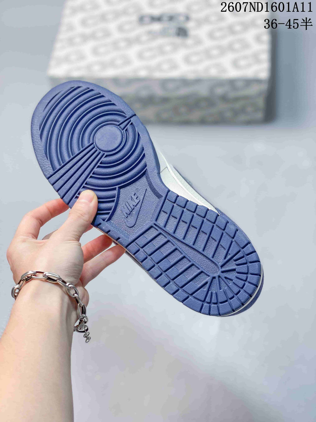 Close-up of the blue rubber outsole showing circular and grid traction patterns with a Nike logo.