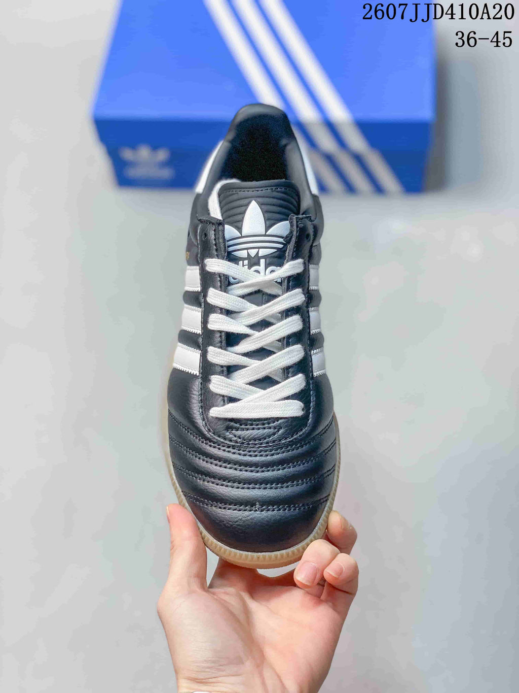 Top view showing the black toe area, white laces, and trefoil tongue logo.