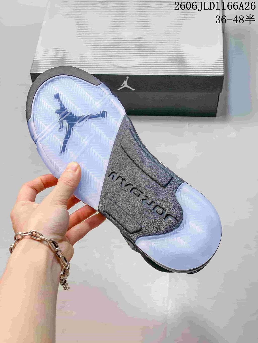 Underside of a Jordan sneaker showing a translucent outsole and dark midfoot section.