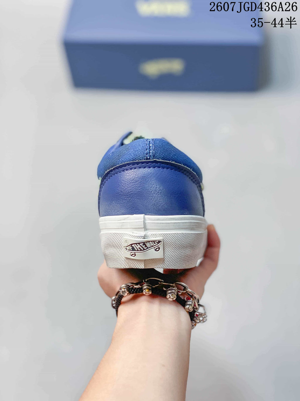 Rear view of the blue sneaker showing the white heel sole and Vans Off The Wall heel label.