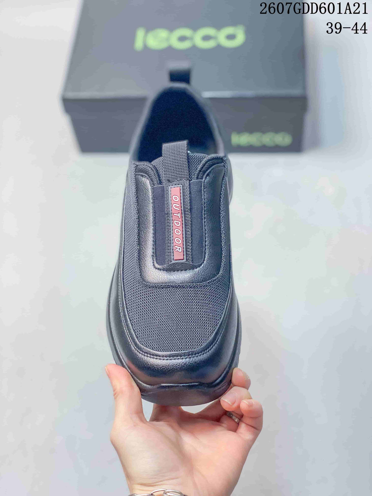 Top view of the black slip-on sneaker showing the textured toe area, elastic side sections, and red outdoor label.