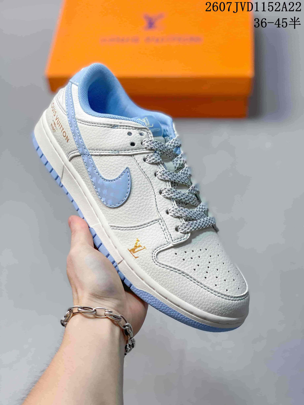 Angled side view showing the white upper, light blue Swoosh and printed heel markings.