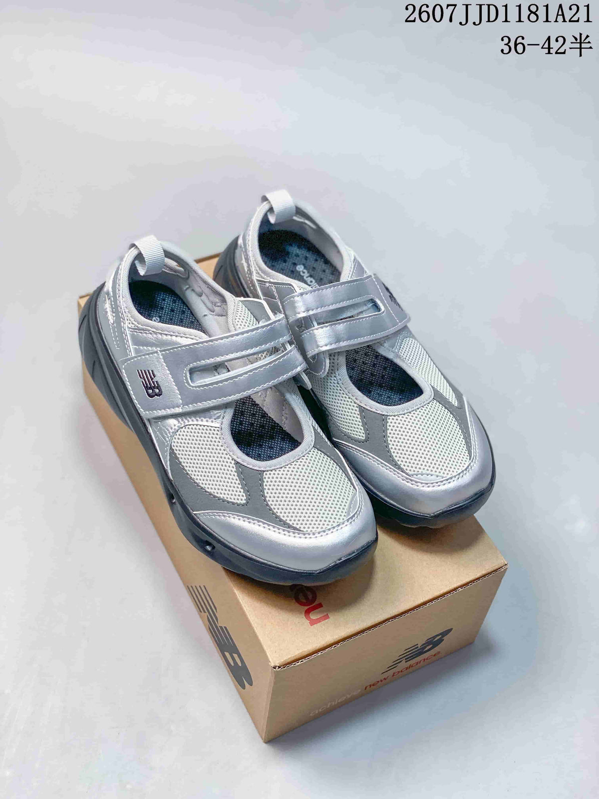 Pair of silver New Balance Breeze sneakers with hook-and-loop straps displayed on a New Balance shoe box.