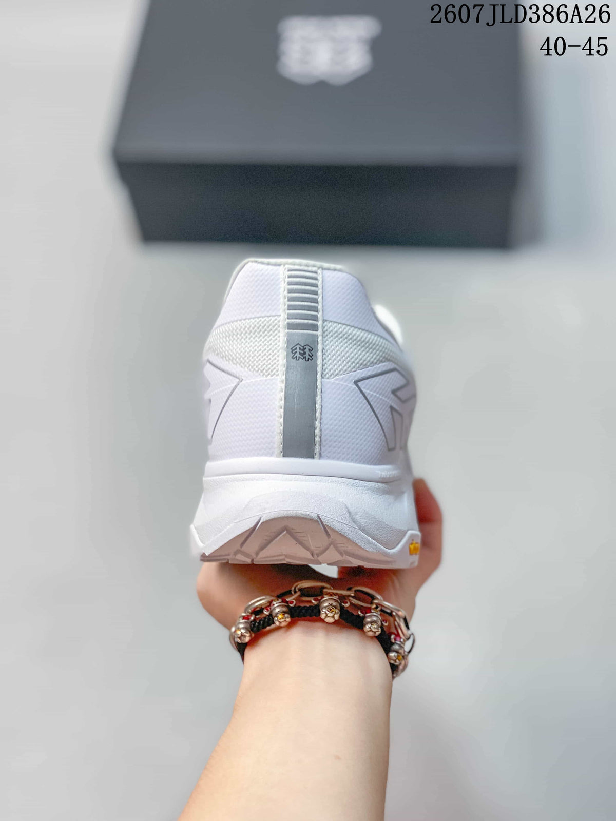 Rear view of the white sneaker showing the padded heel collar, vertical heel detail and textured outsole.