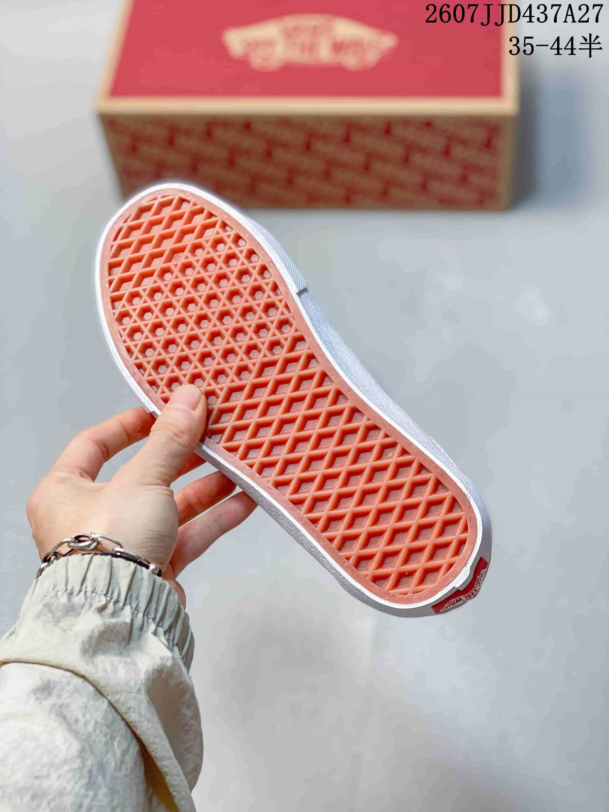 Underside of the sneaker showing the orange waffle-patterned outsole.