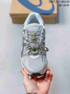 Top view of the ASICS Gel-Kahana 8 FL sneaker showing the mesh-textured upper, toggle-style lacing, and green accents.