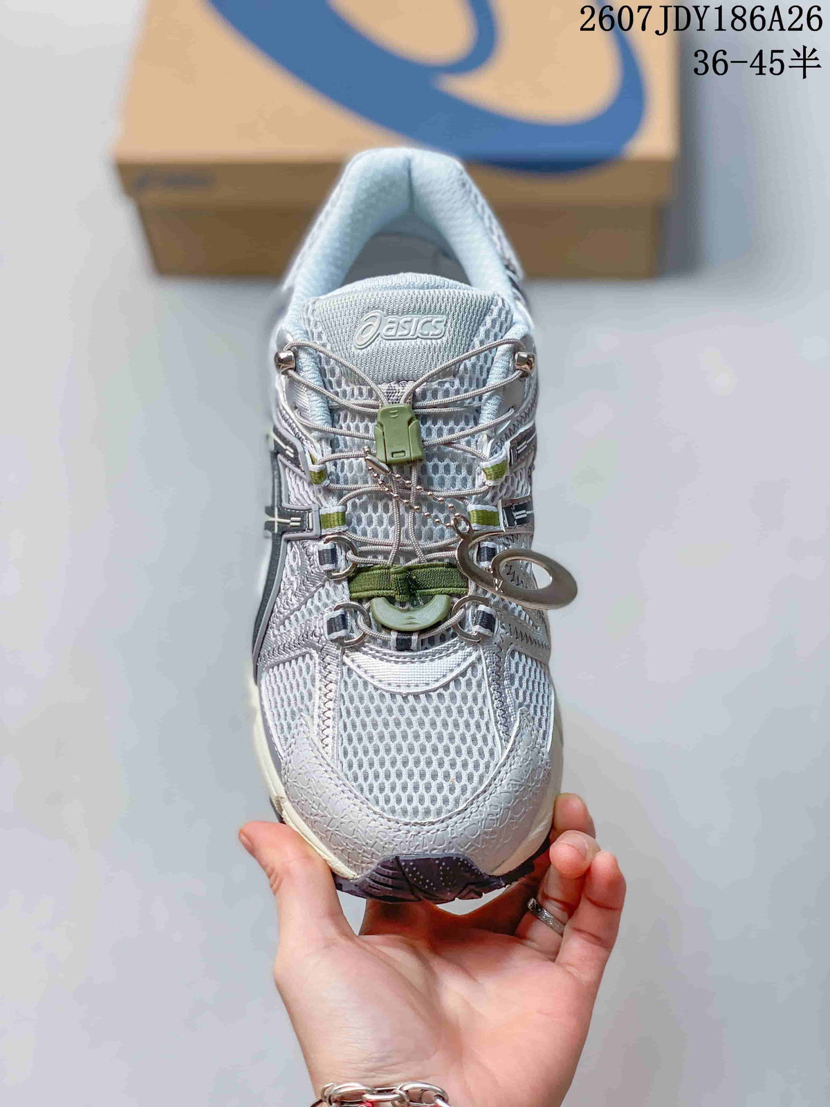 Top view of the ASICS Gel-Kahana 8 FL sneaker showing the mesh-textured upper, toggle-style lacing, and green accents.