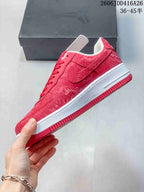 Side view of a red patterned low-top sneaker with a white midsole