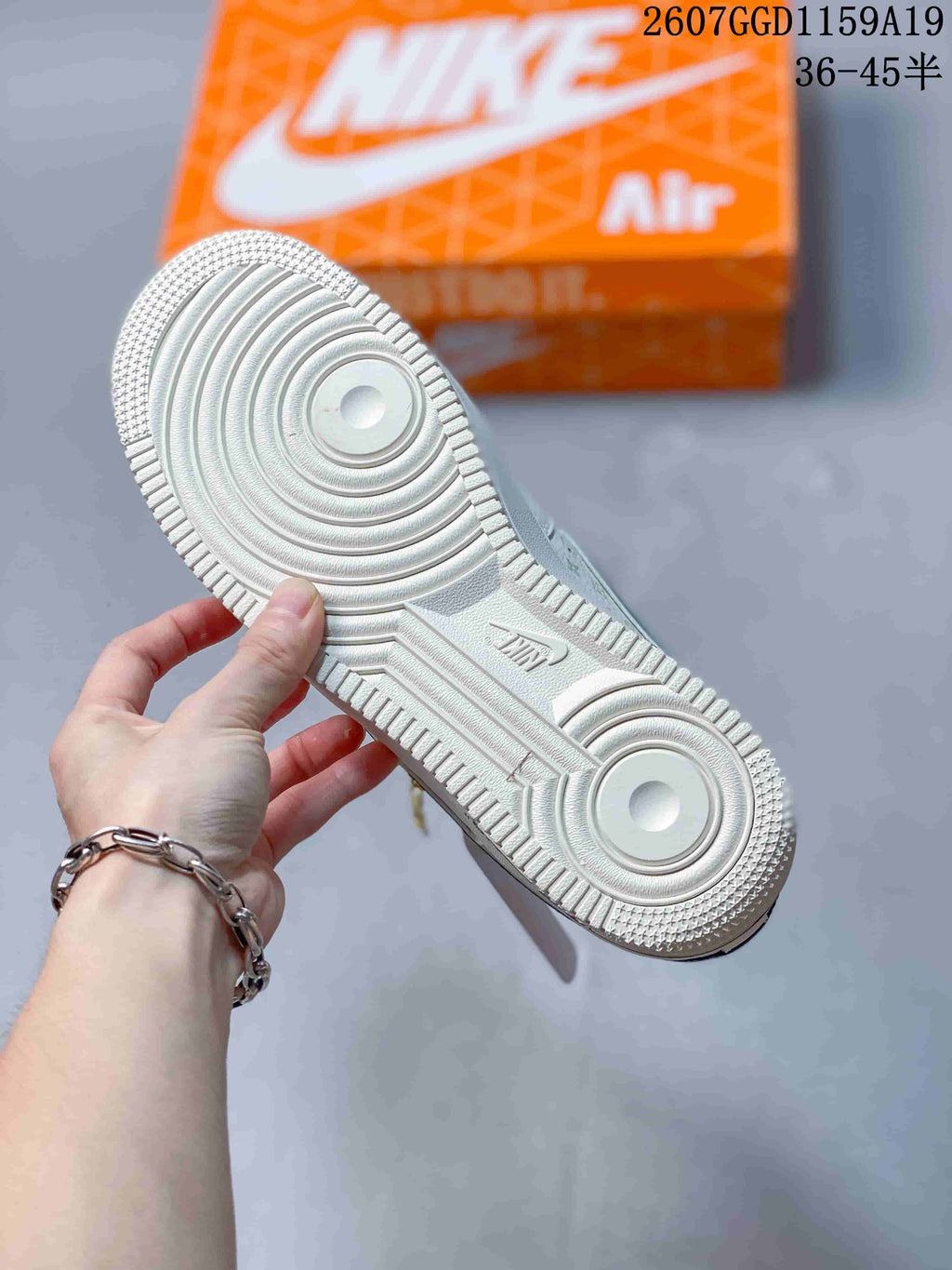 Close-up of the white textured outsole with concentric circular traction patterns and Nike branding.