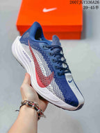 Angled side view showing the navy, white and red upper, red Swoosh detail, lace-up construction and white midsole.