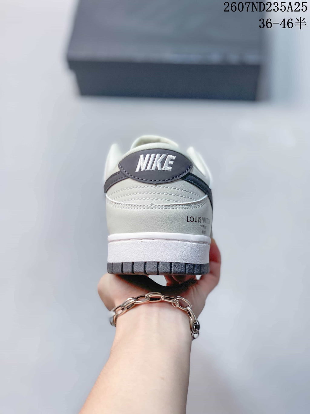 Rear view of the sneaker showing the heel branding, layered panels and dark outsole edge.