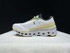 Opposite side profile of a white and lime Cloudmonster 2 shoe.