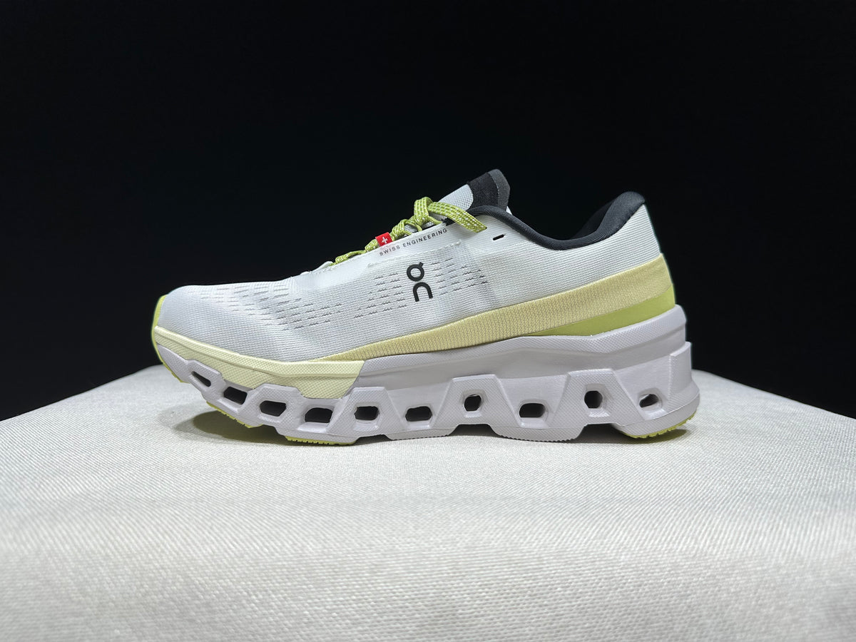 Opposite side profile of a white and lime Cloudmonster 2 shoe.