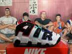 Side view showing oversized AIR lettering on a white, black, red, teal, and blue sneaker.