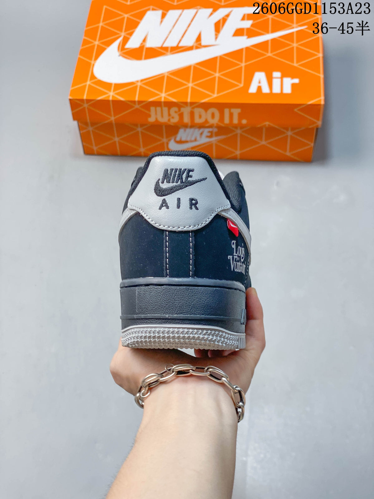 Rear view of a dark navy Air Force 1 sneaker with a gray heel tab